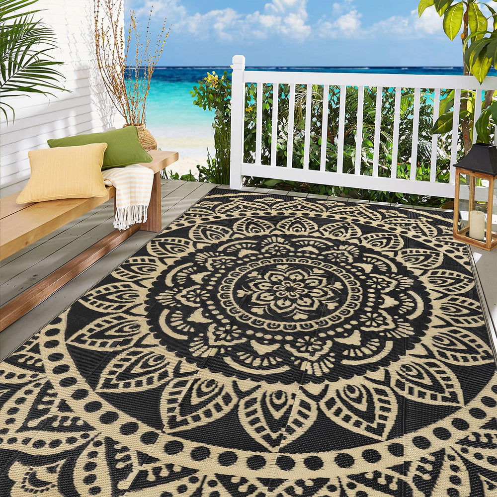 Close-up of Bsmathom outdoor rug showing flower black gold pattern