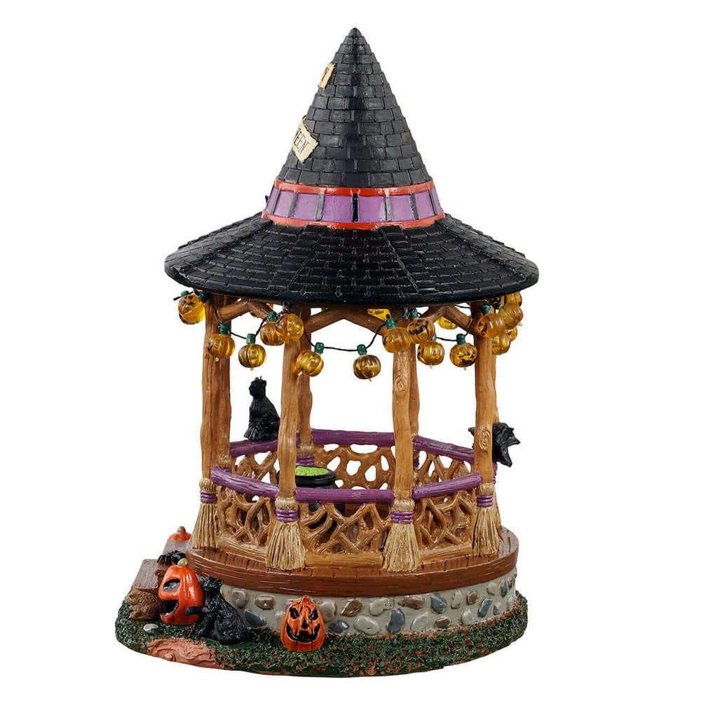 Close-up of cauldron, black cat, and bat inside the Lemax Witch Gazebo