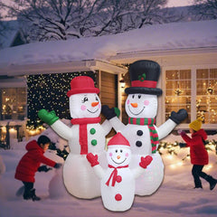 Close-up of DILENK inflatable snowman family in green outfits
