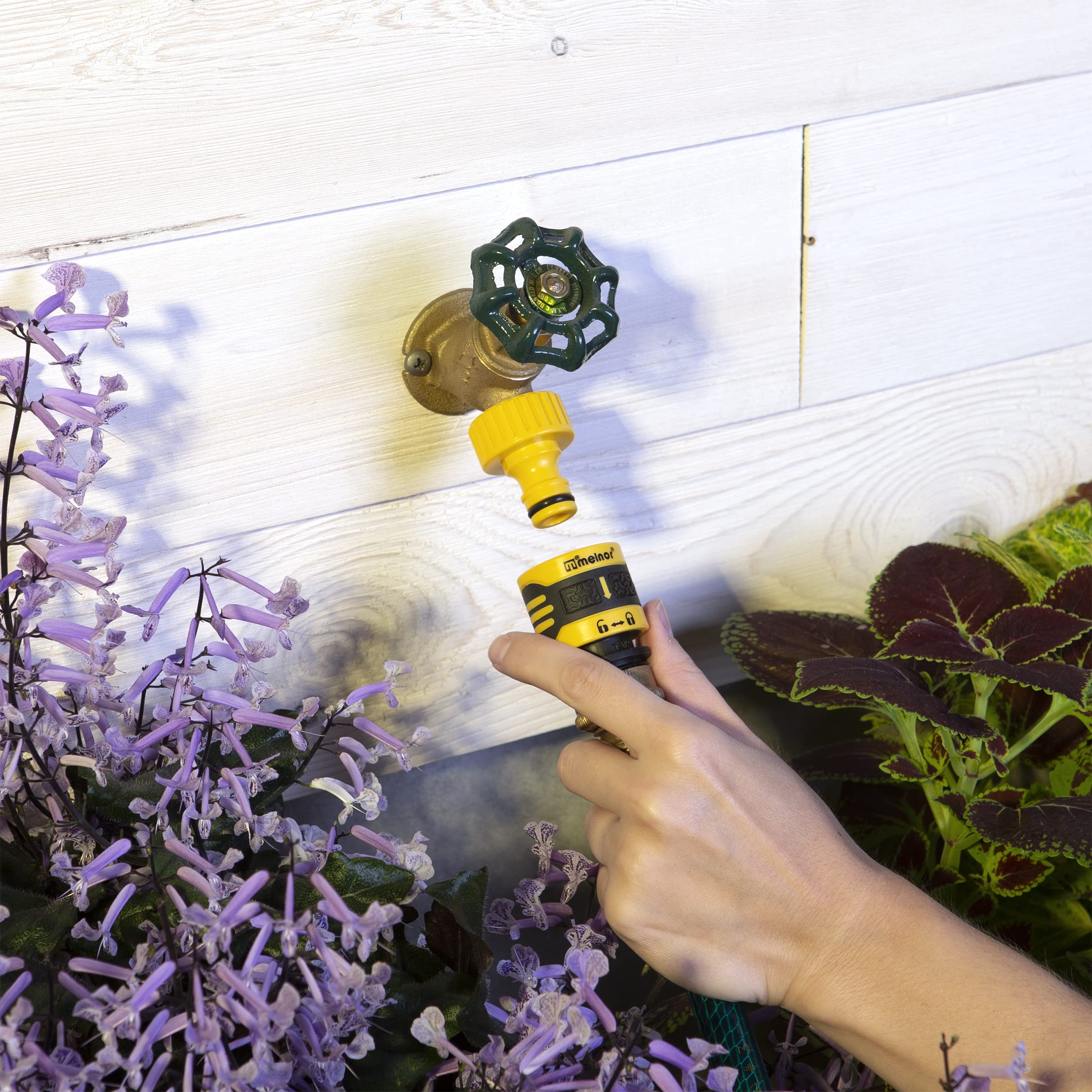 Close-up of Melnor faucet adapter in yellow and black