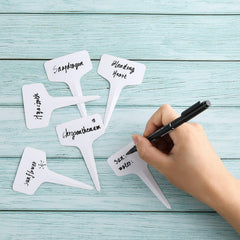 Close-up of NadaKin plant labels showing writing area