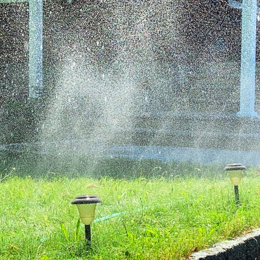 Close-up of the Flexon sprinkler hose showing the three-tube design