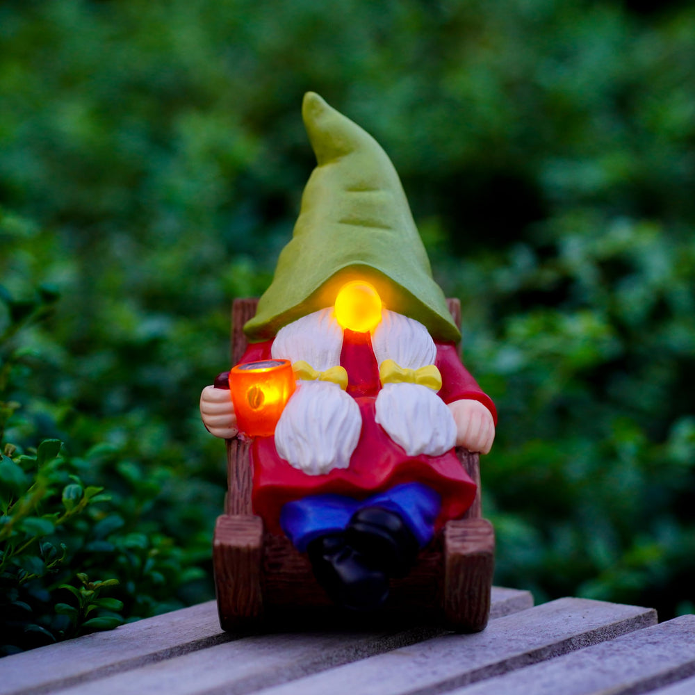 Close-up of the glowing LED nose and coffee cup of the gnome
