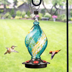 Close-up of the teal hummingbird feeder showing the spiral glass detail