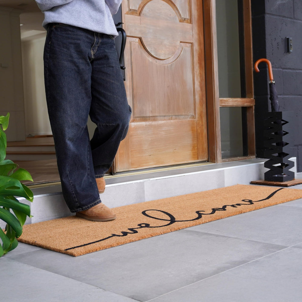 Close-up of THEODORE MAGNUS Welcome Mat texture showing coir fiber