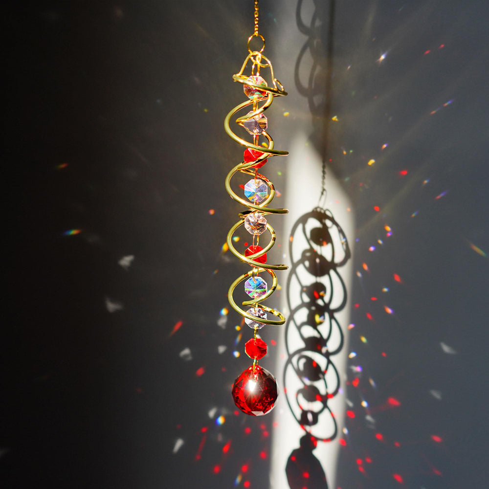 Close-up of vibrant red crystal glass ball on the wind spinner