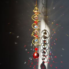 Close-up of vibrant red crystal glass ball on the wind spinner