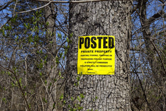 Close-up of Wristco yellow property sign text