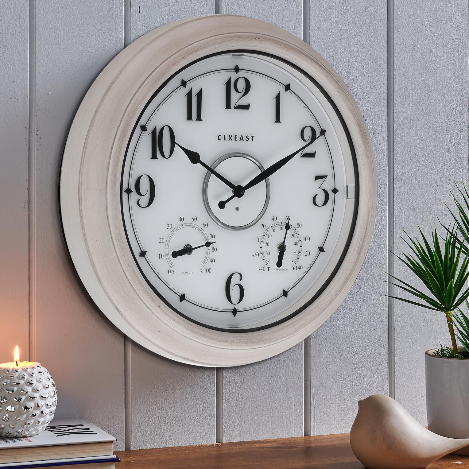 CLXEAST 18 inch outdoor clock mounted on a patio wall
