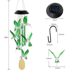 Colorful display of hummingbird wind chimes at night