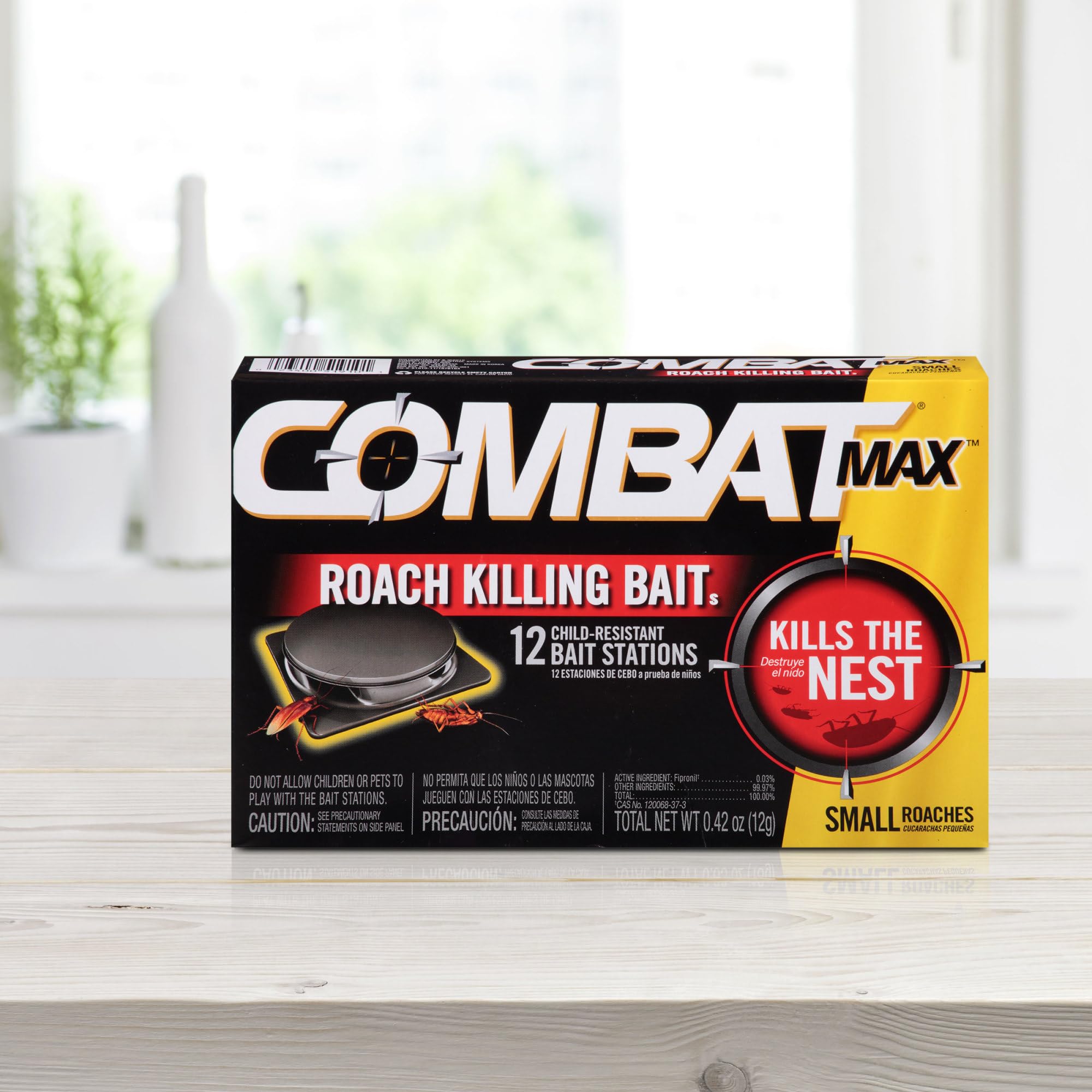 Combat Max gel syringe with bait stations on a countertop