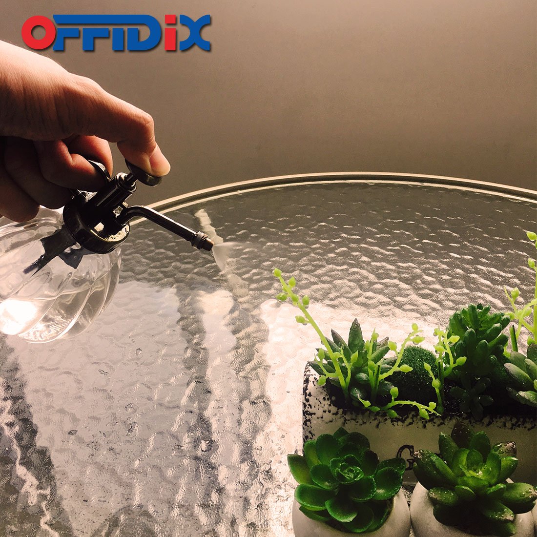 Comparison of OFFIDIX Watering Spray Bottle next to traditional watering can