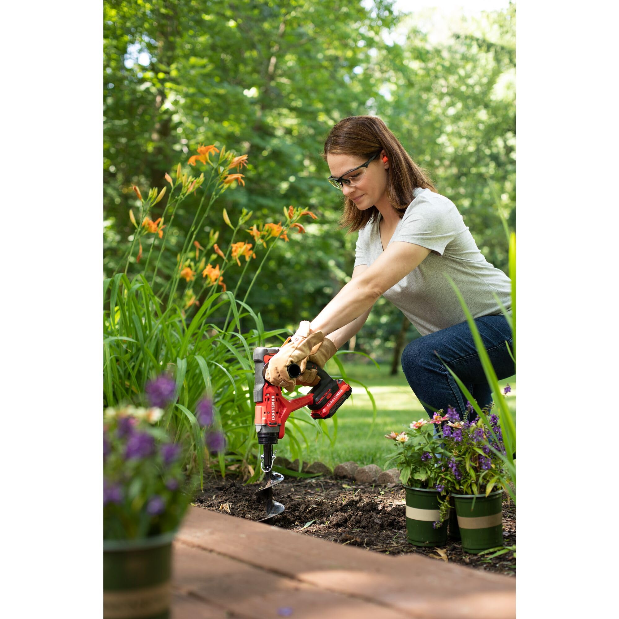 CRAFTSMAN V20 cordless tool kit on a garden background