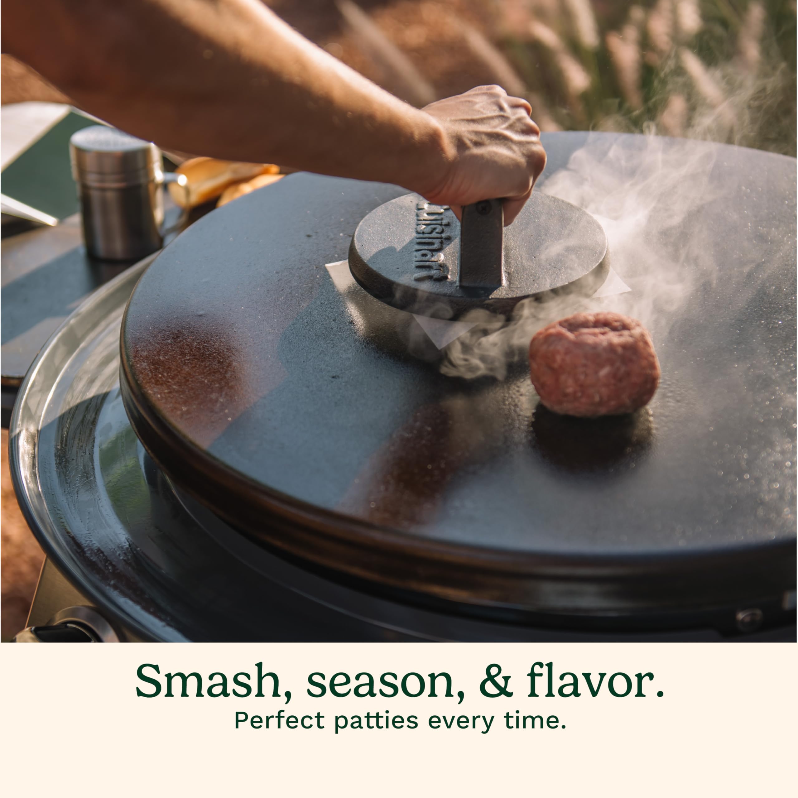 Cuisinart burger press in use on a skillet