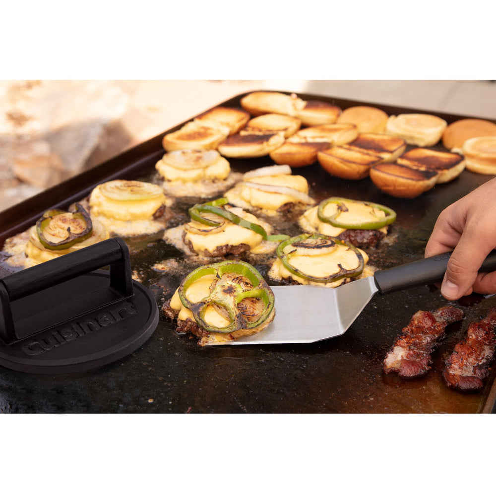 Cuisinart cast iron burger press on a wooden table