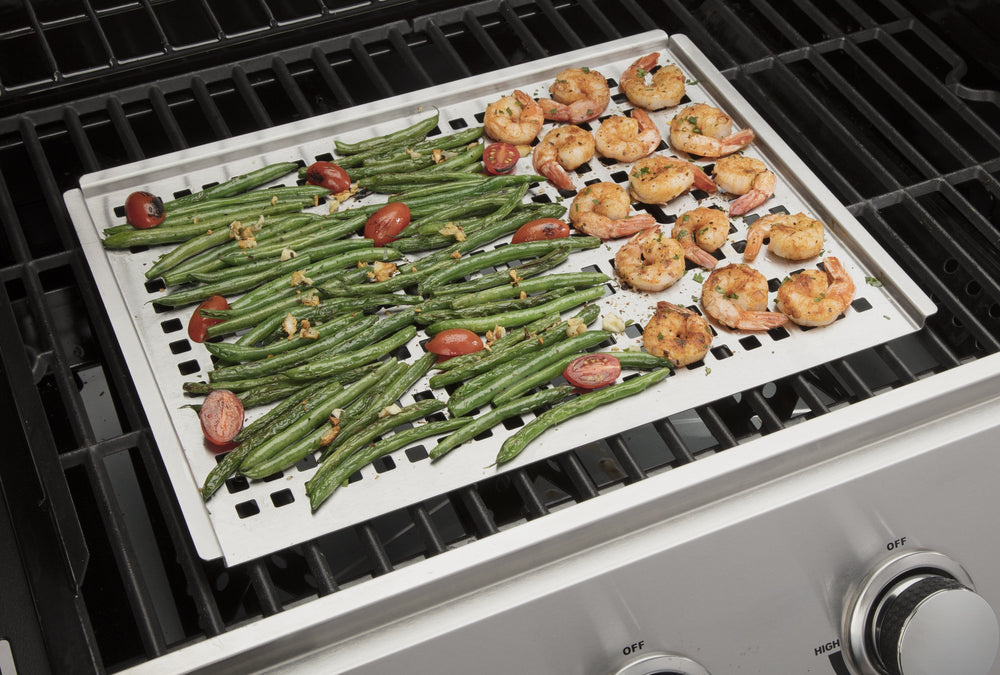 Cuisinart grill topper on a grill with vegetables