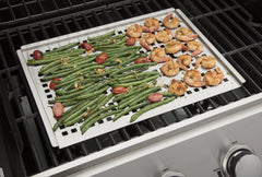 Cuisinart grill topper on a grill with vegetables