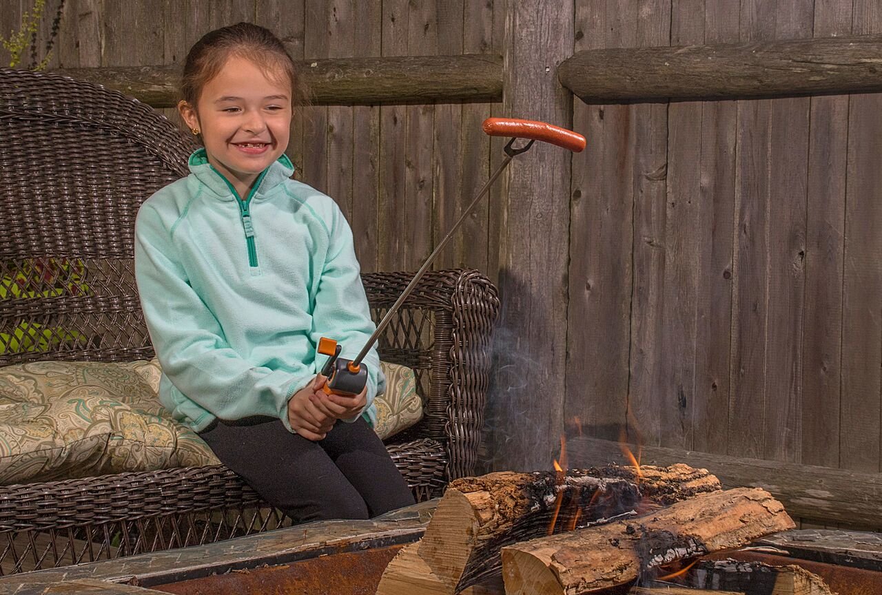 Cuisinart Roasting Reel with marshmallows roasting over fire