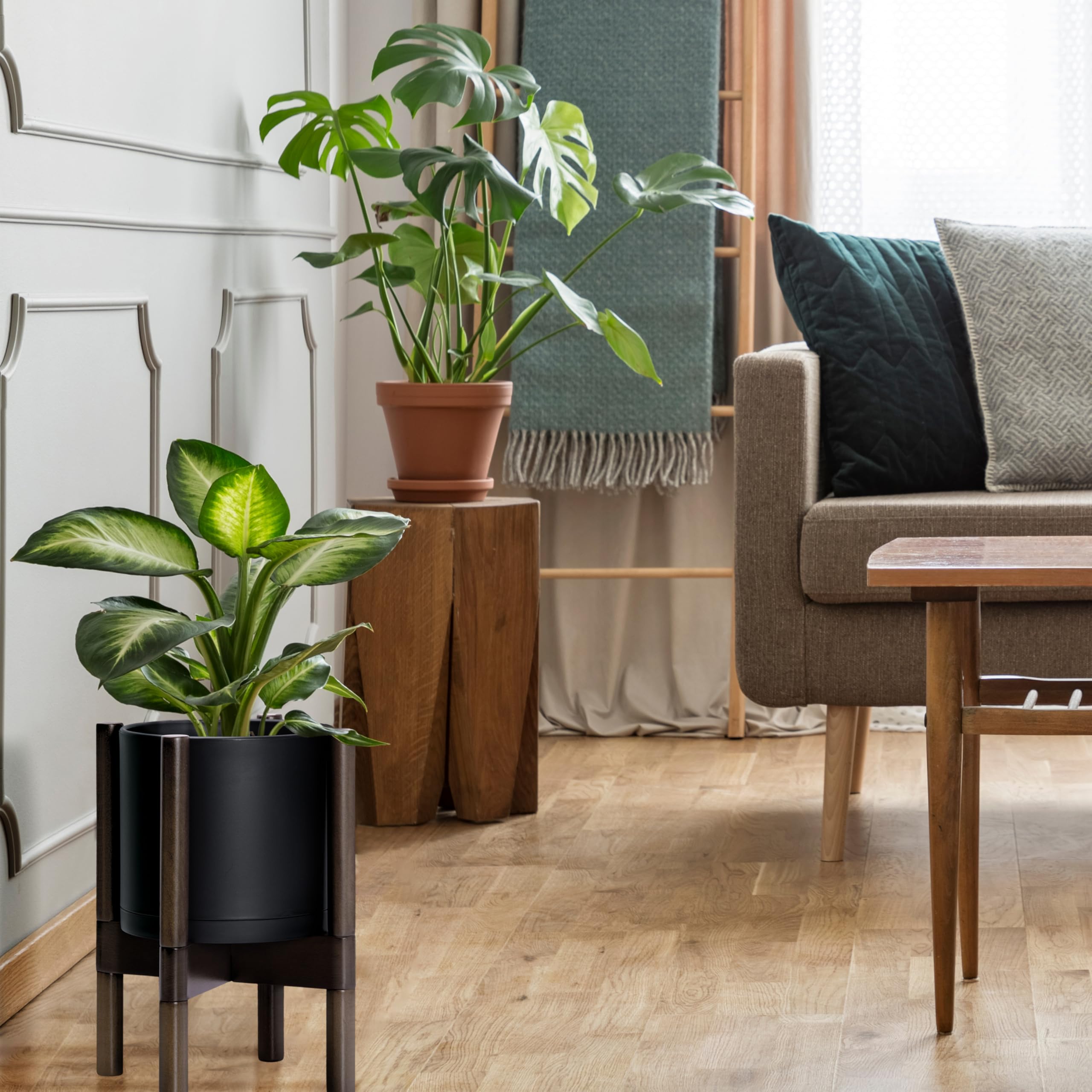 D'vine Dev 8 inch planter with plants inside on walnut stand