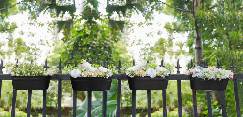Dahey 15 Inch Railing Planters, Black, in a garden setting