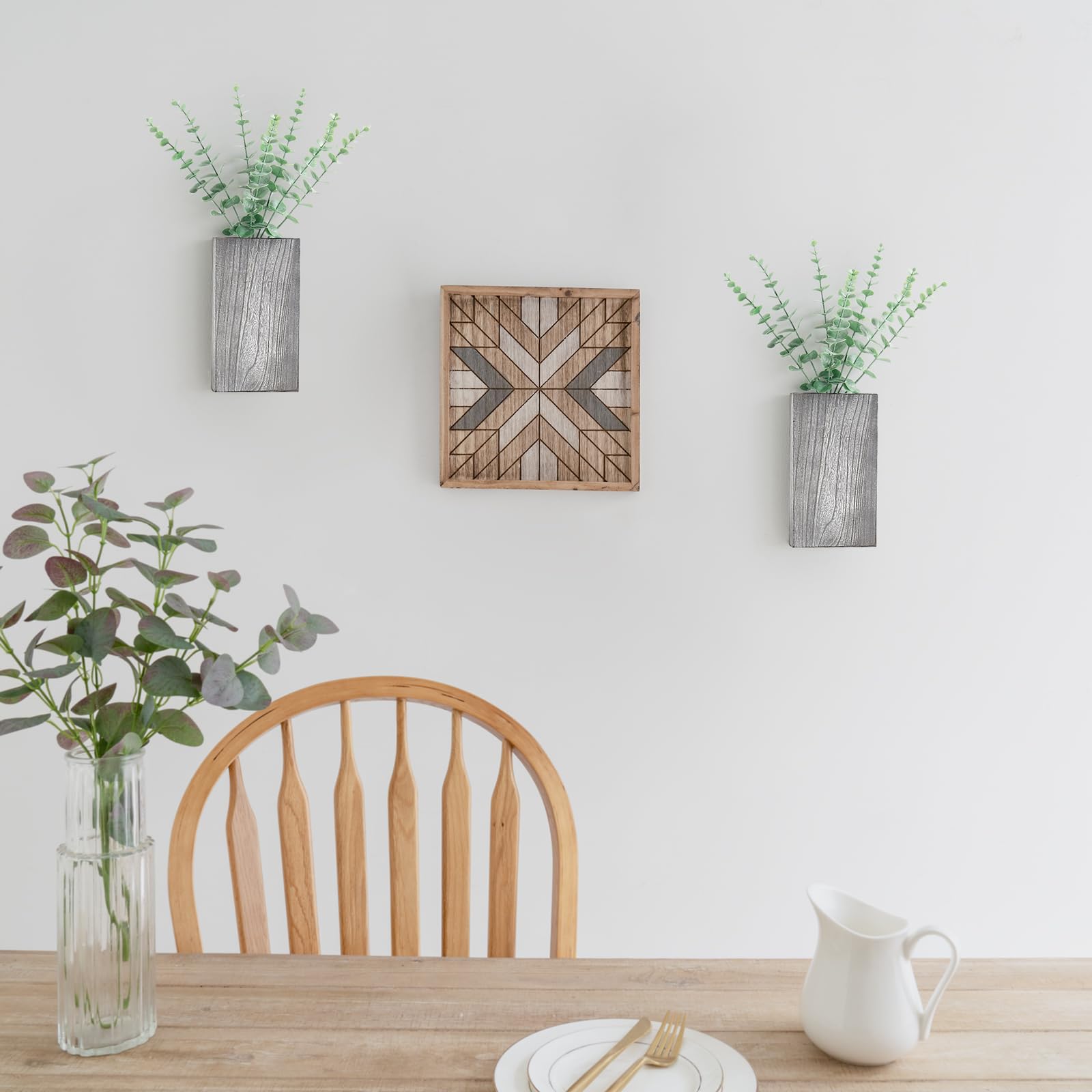 Dahey wall planters hanging on a wall with eucalyptus