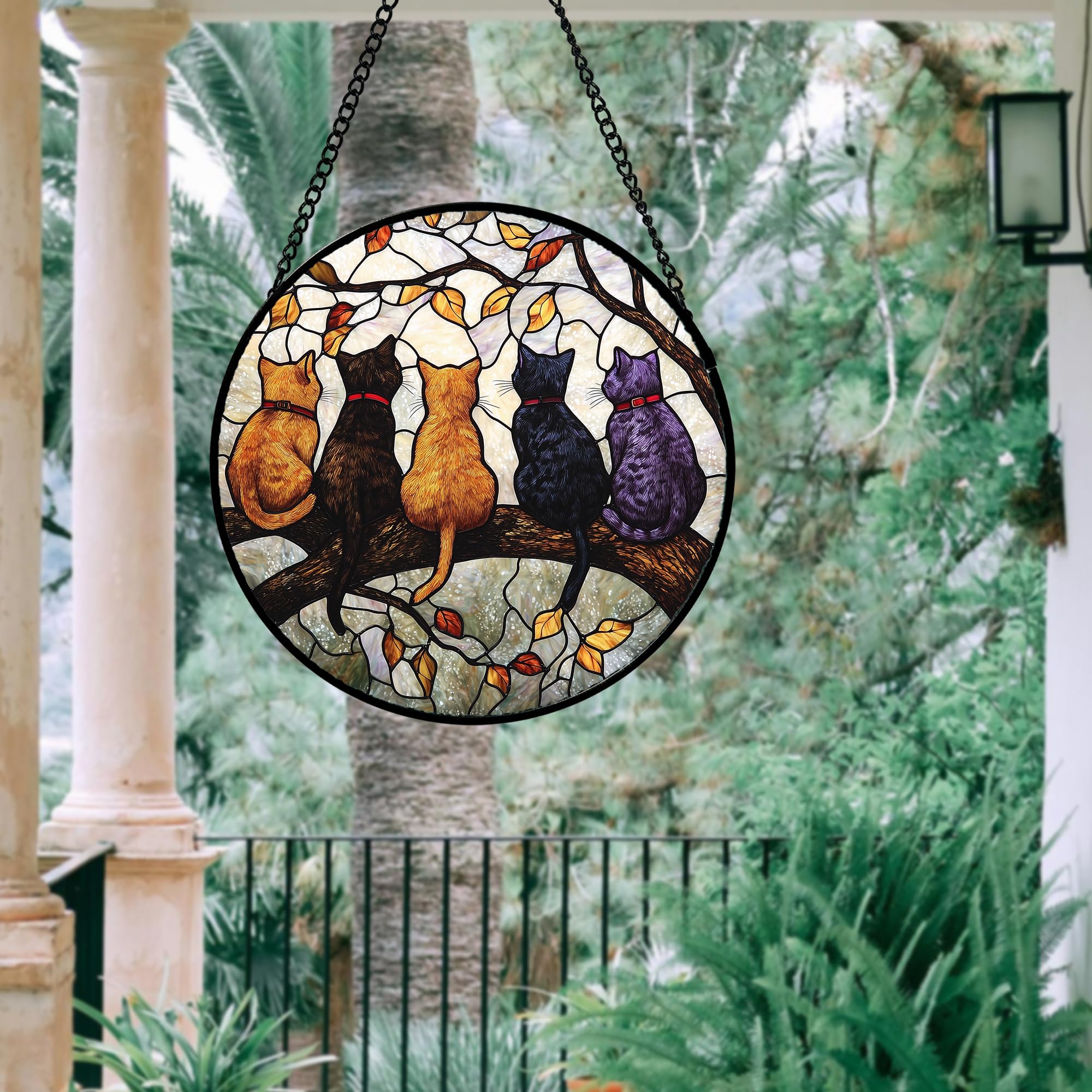 DASTOLL stained glass window hanging in a garden setting