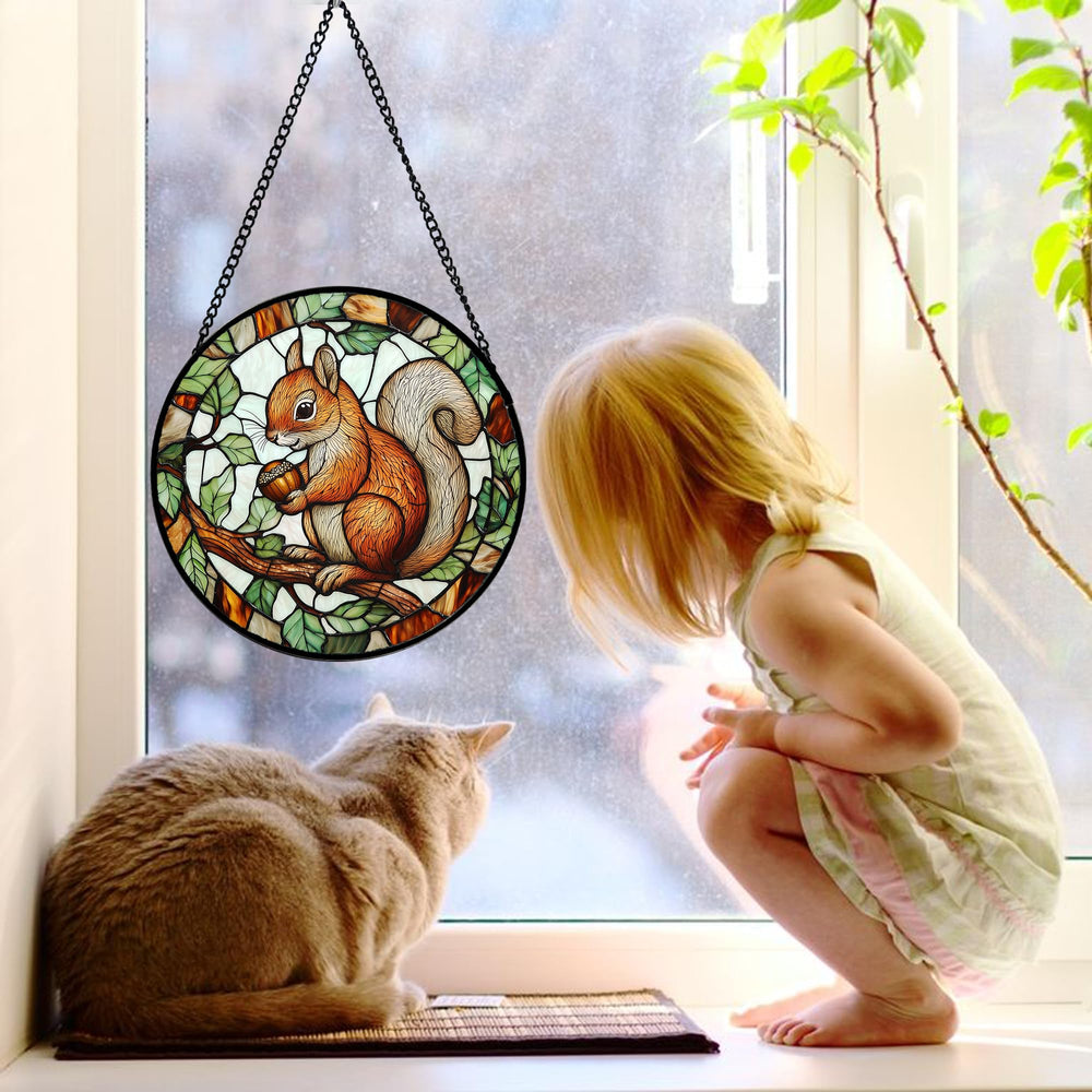 DASTOLL suncatcher hanging in a window with sunlight shining through