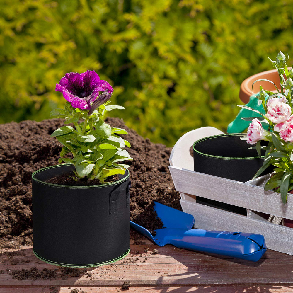 Delxo 10 Gallon Grow Bags with handles in a garden setting
