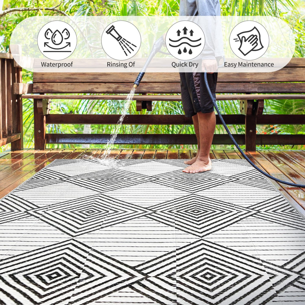 DiiKoo black and white reversible outdoor rug laid on patio