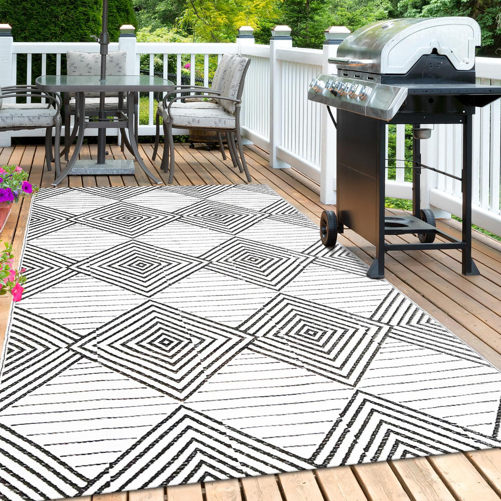 DiiKoo outdoor rug displayed in a backyard setting