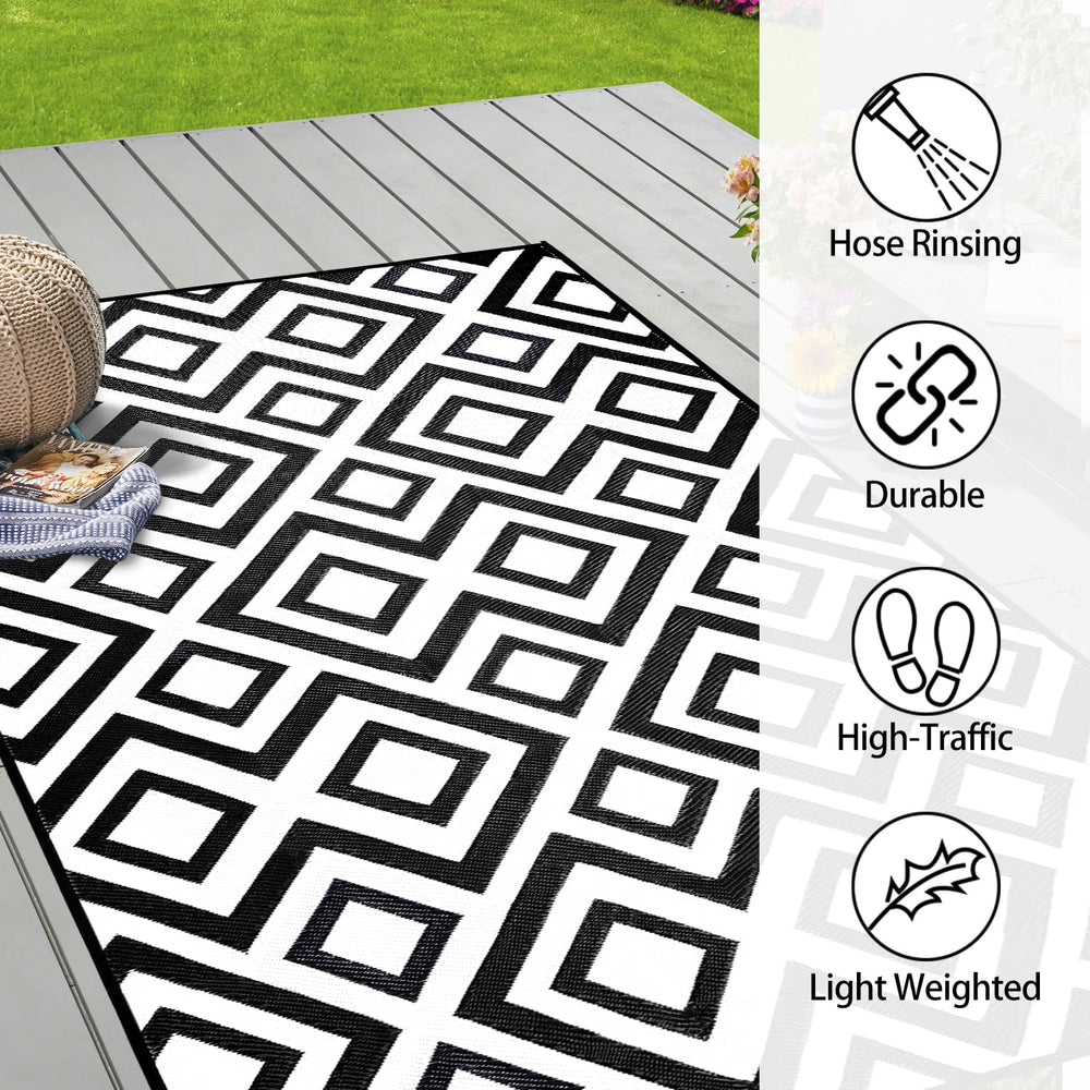 DiiKoo Outdoor Rug laid out on a grassy area