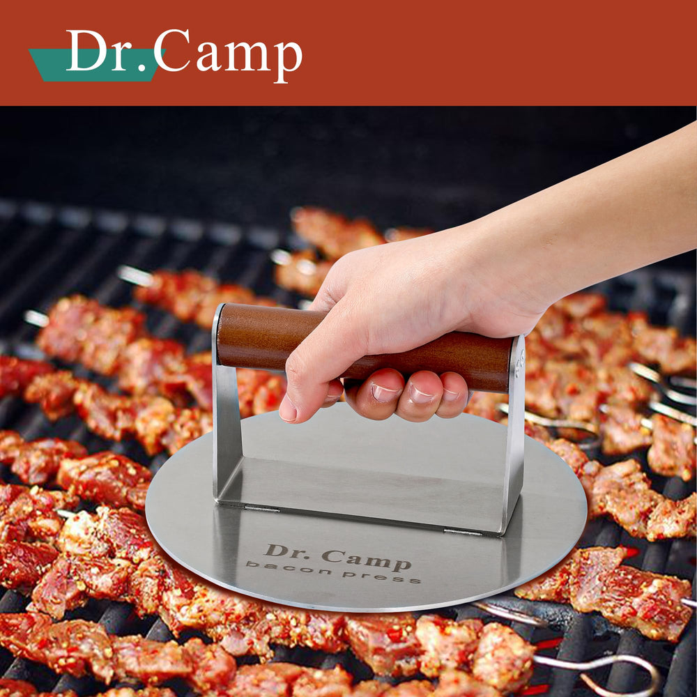 Dr.Camp burger press in use on a griddle