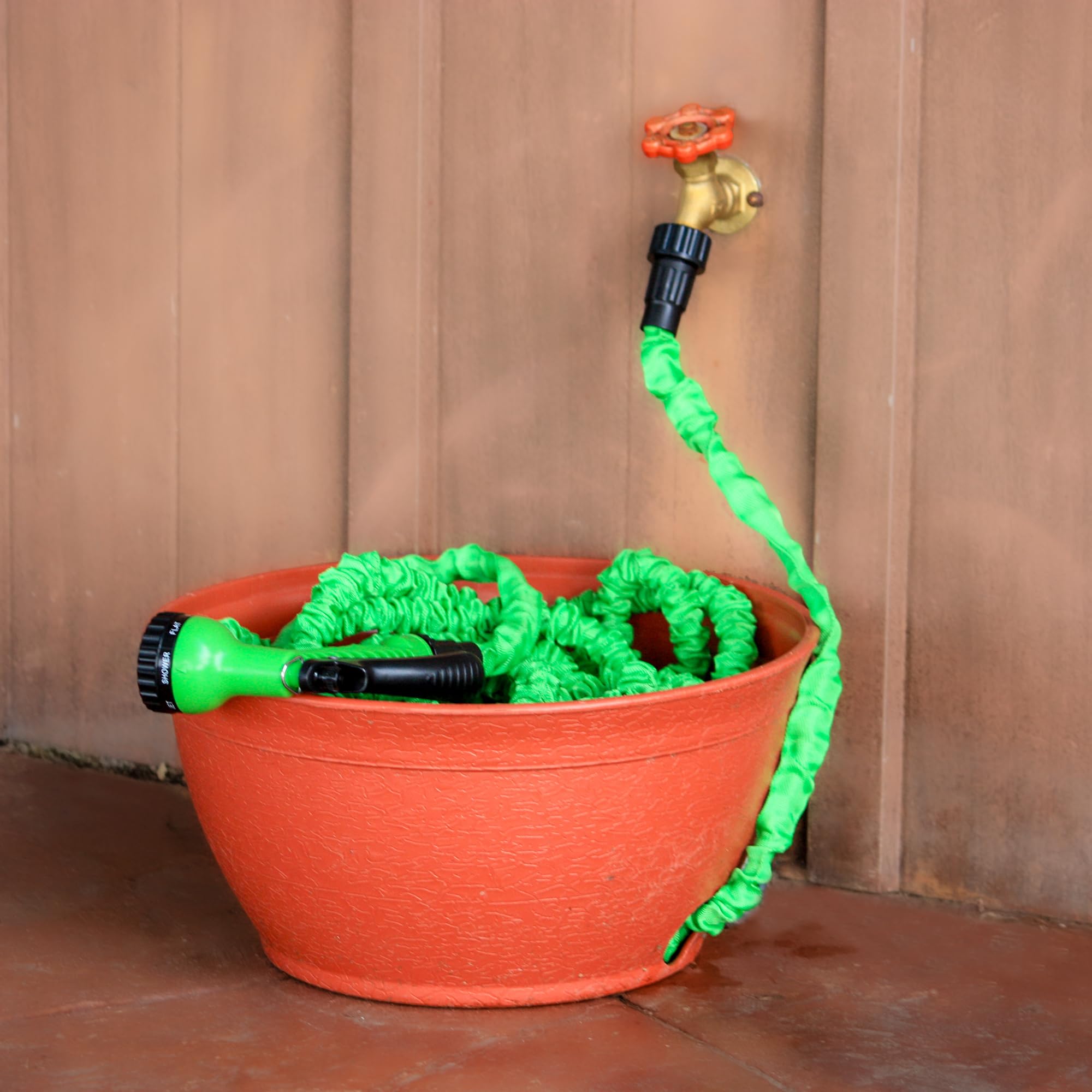 Emsco Expandable Hose Hider displayed on a porch with garden tools