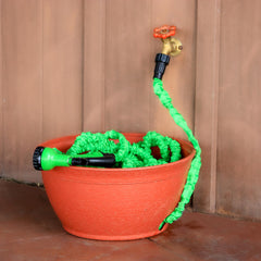 Emsco Expandable Hose Hider displayed on a porch with garden tools