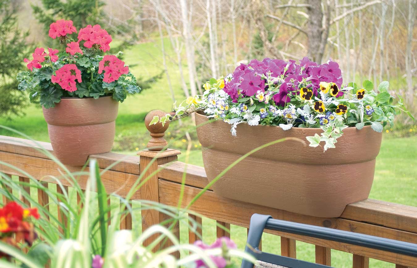 Emsco Group Bloomers Railing Planter dimensions shown on a measuring tape