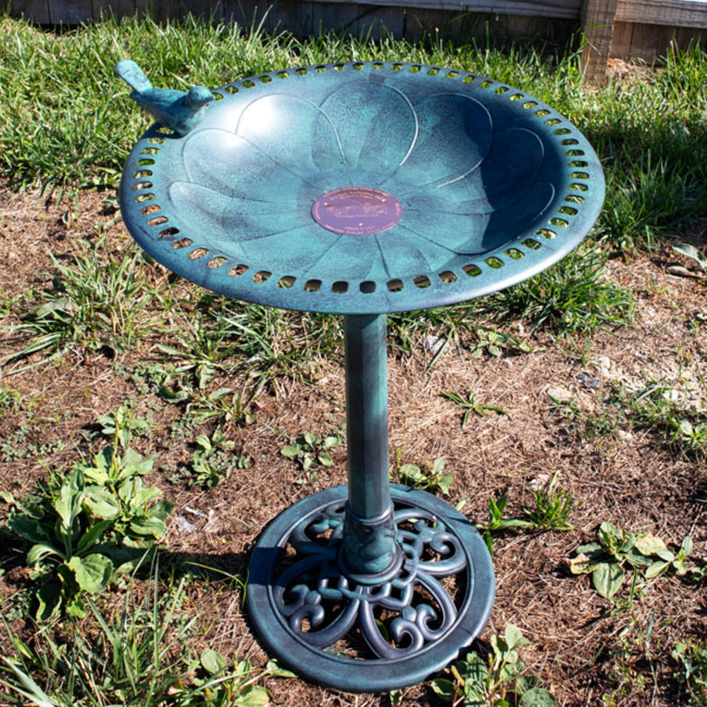 Erva Copper Bird Bath Purification Disk in a garden setting