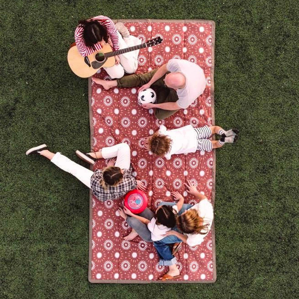Family enjoying a picnic on the Little Unicorn blanket