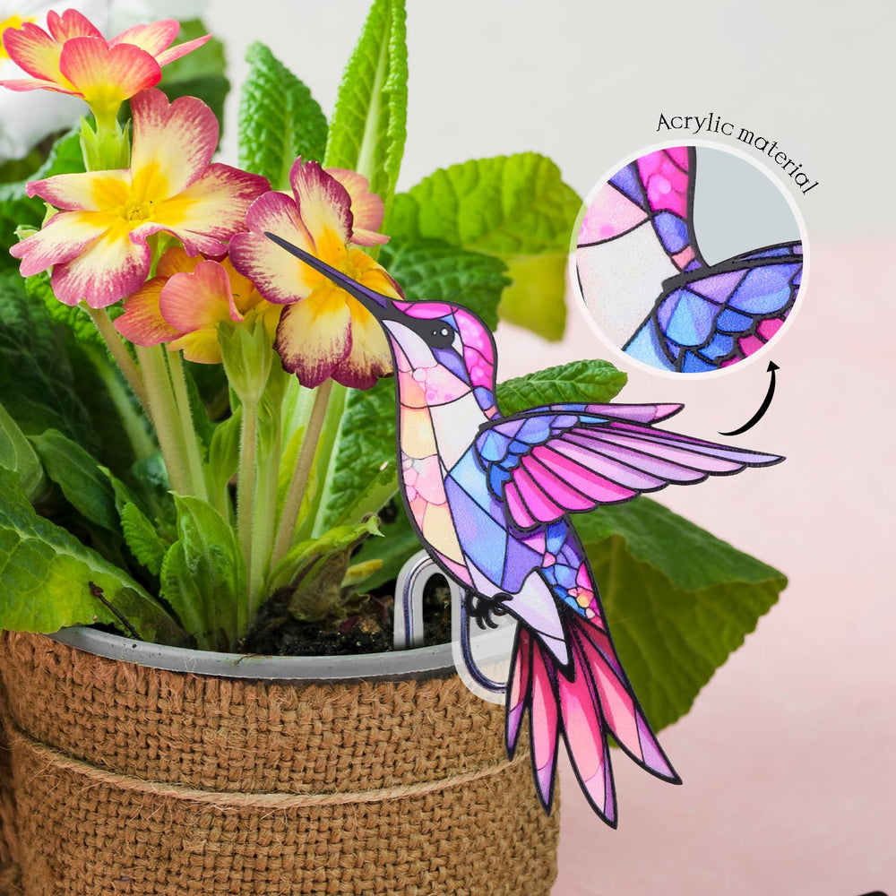 FBBP Hummingbird Planter attached to a flower pot in a garden