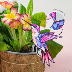 FBBP Hummingbird Planter attached to a flower pot in a garden
