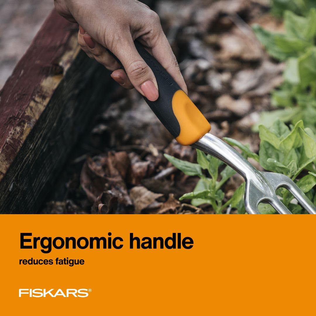 Fiskars Ergo Cultivator being used for aerating soil