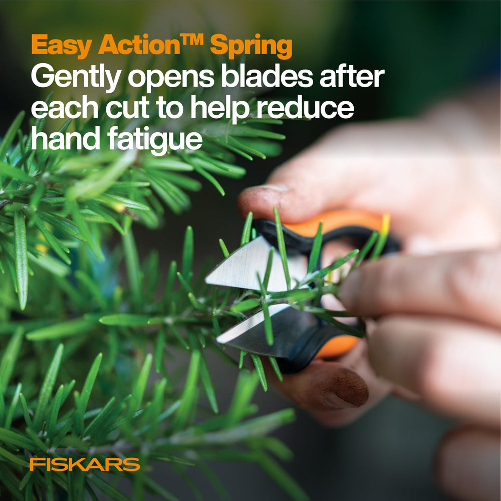 Fiskars Herb Snips on a wooden cutting board with herbs