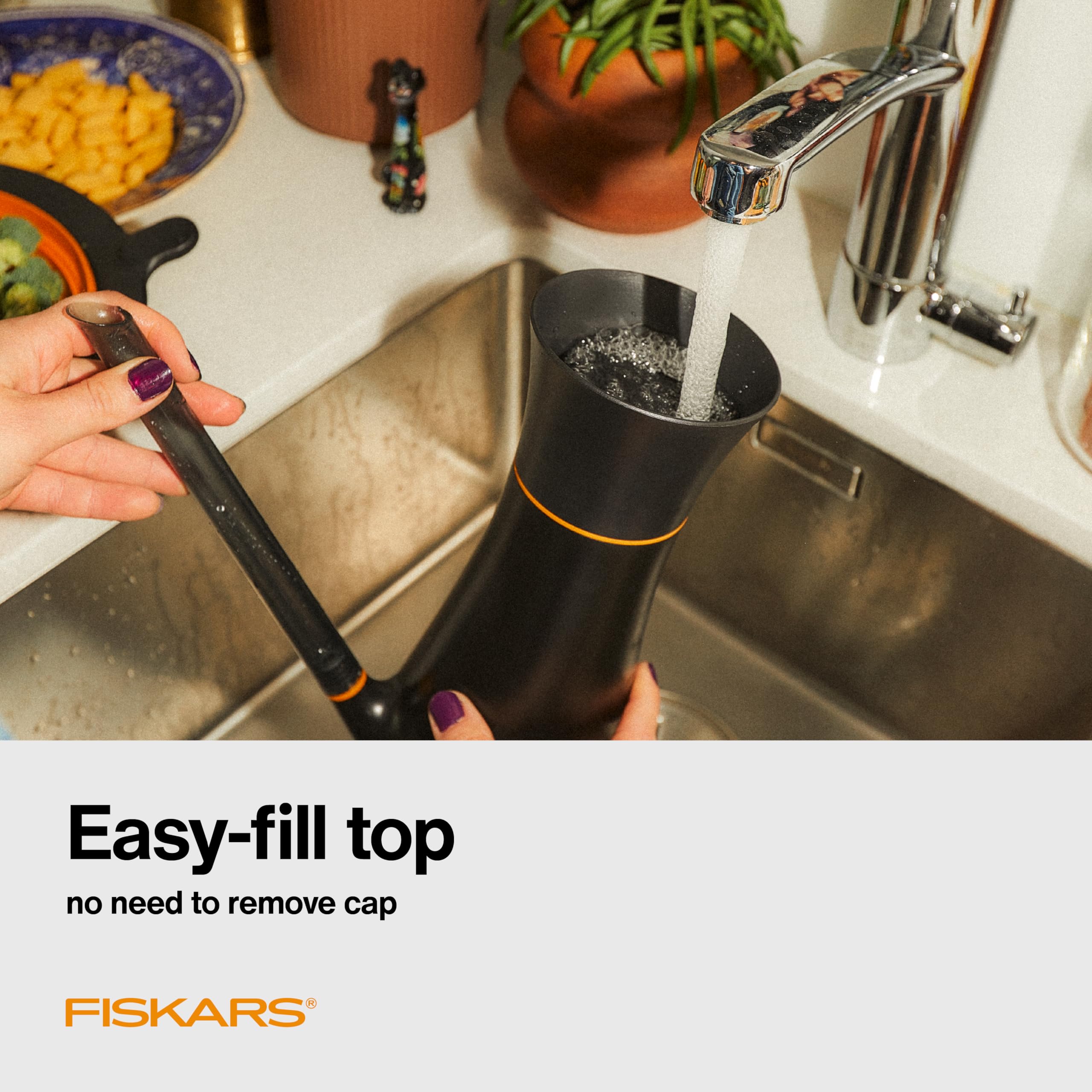 Fiskars Indoor Watering Can being filled with water