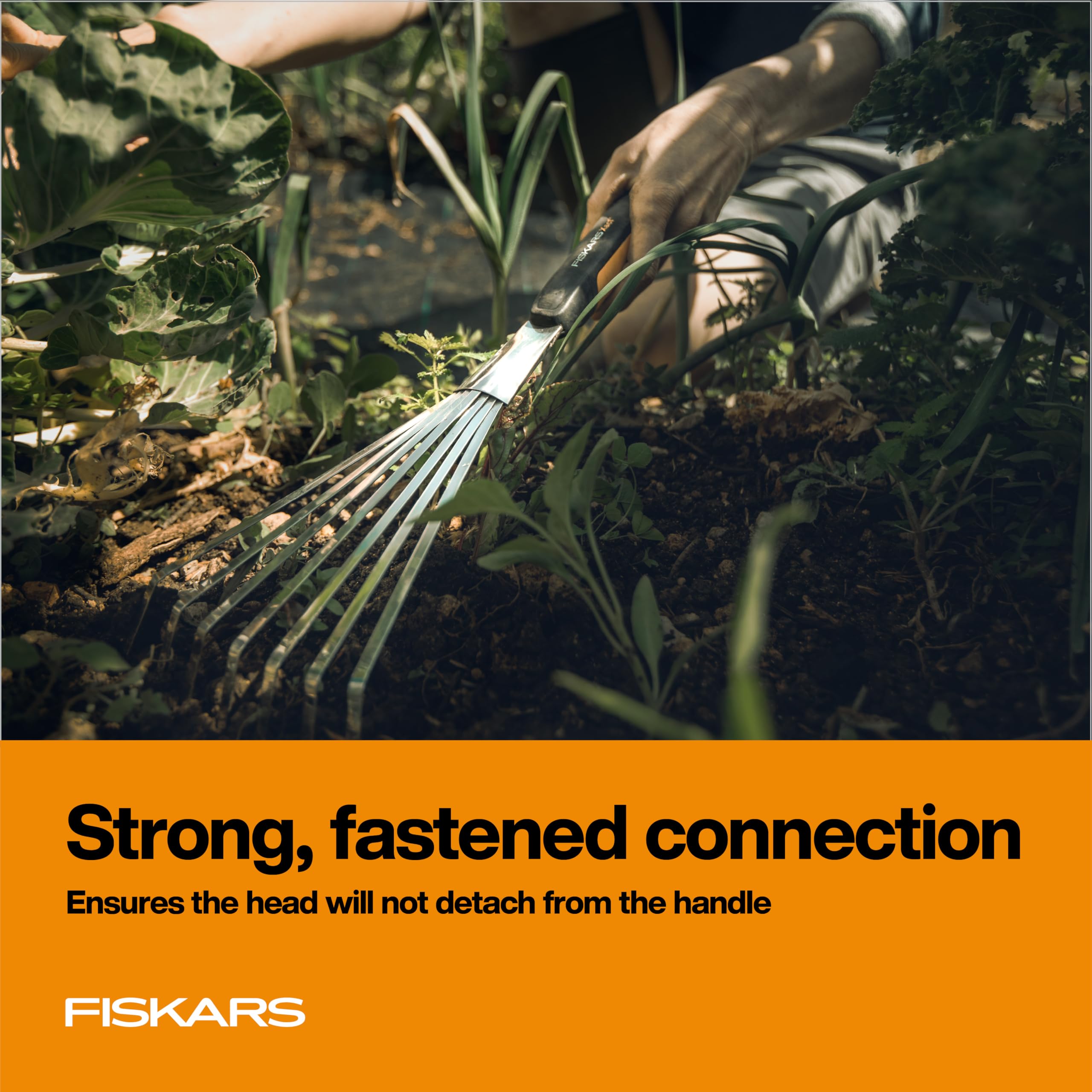 Fiskars Xact Hand Rake in a flowerbed for precise raking