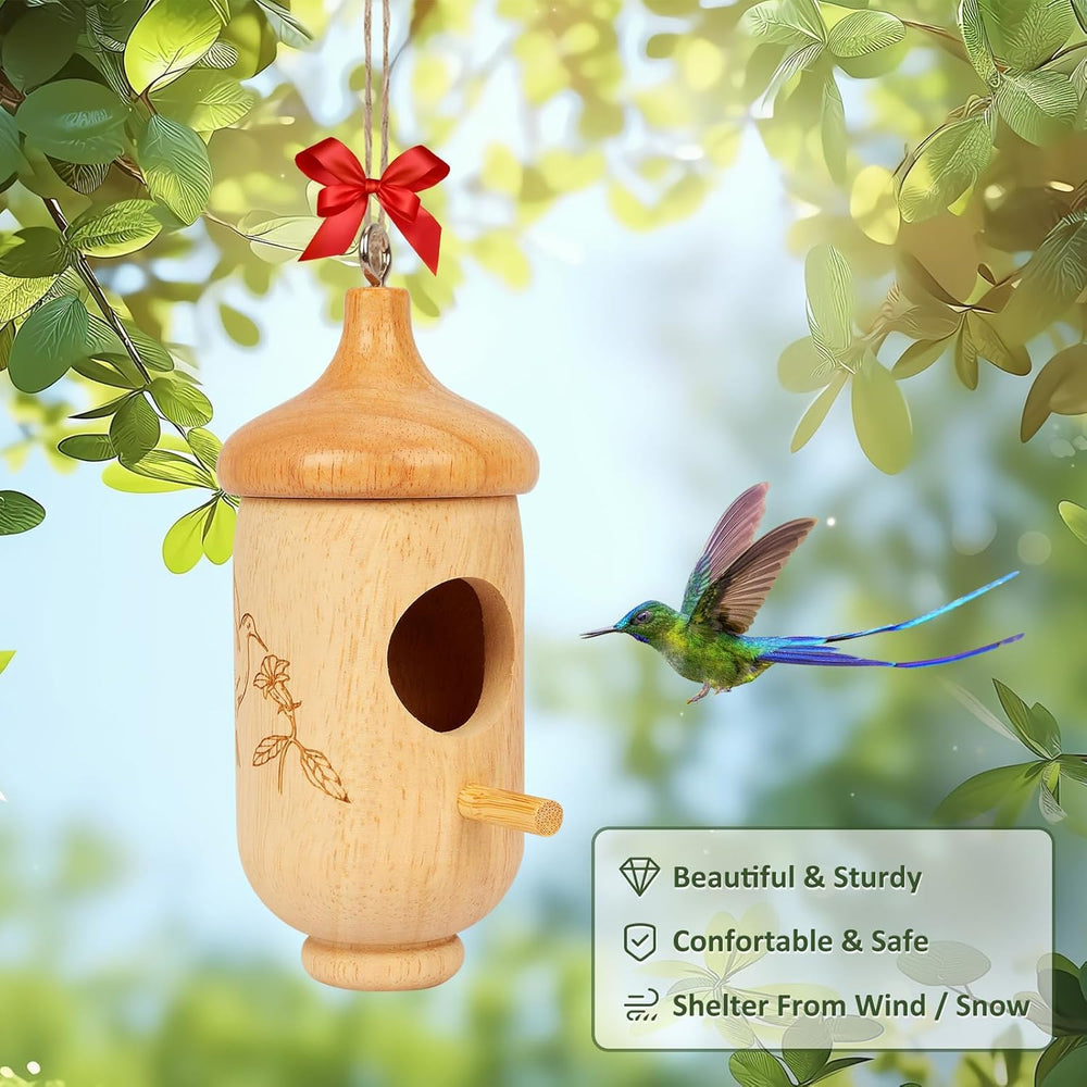 Fitraho Hummingbird House in a garden setting with flowers