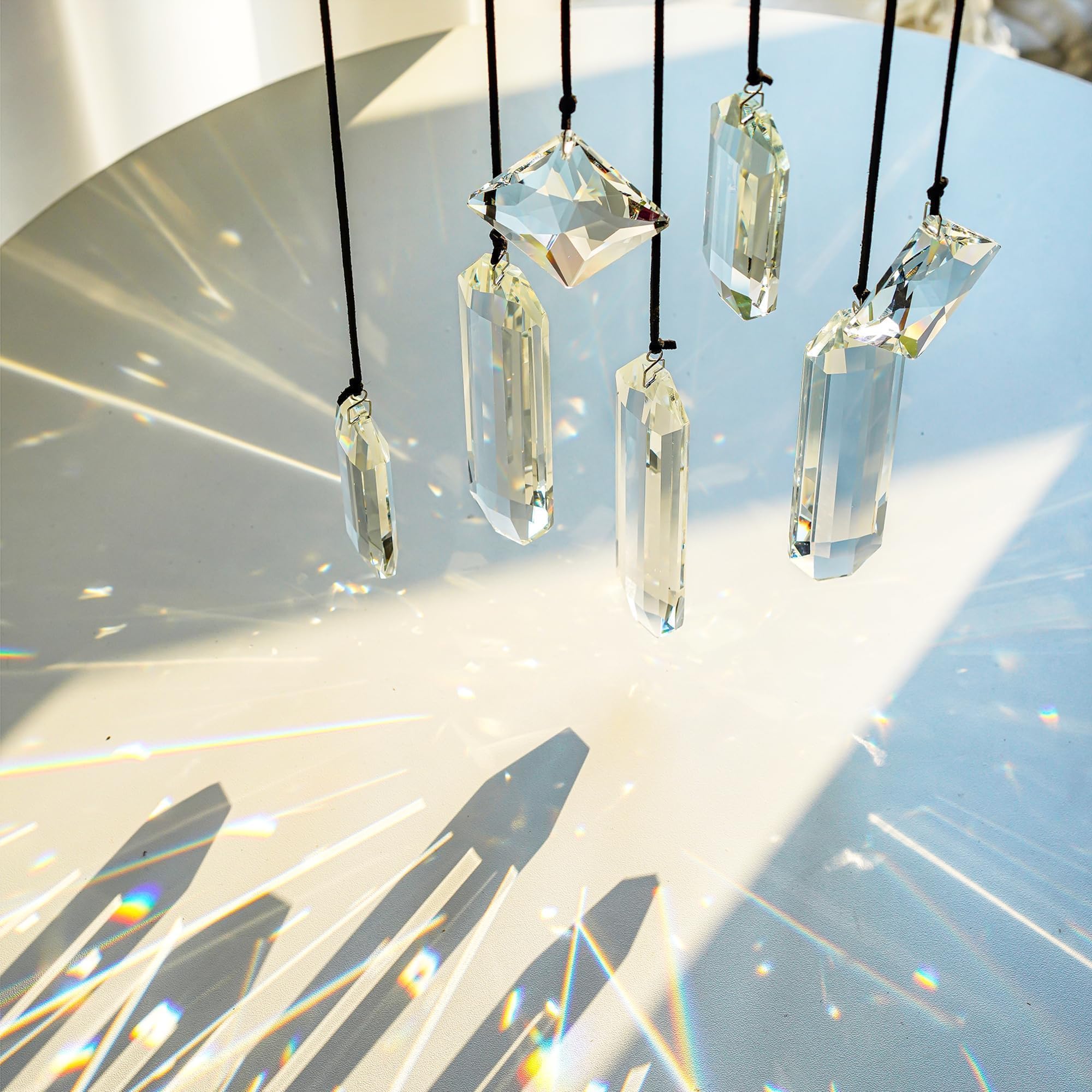 Flat lay of HDCRYSTALGIFTS Clear Crystal Prisms with cords and hooks