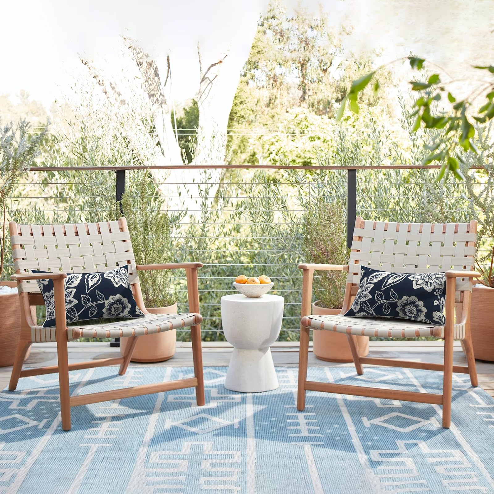 Flat lay of LVTXIII lumbar pillow covers on patio furniture