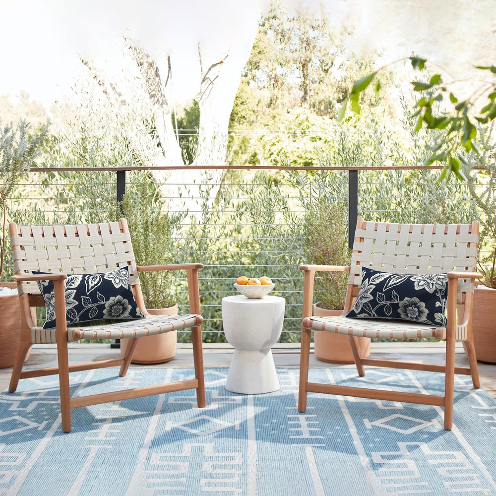 Flat lay of LVTXIII lumbar pillow covers on patio furniture