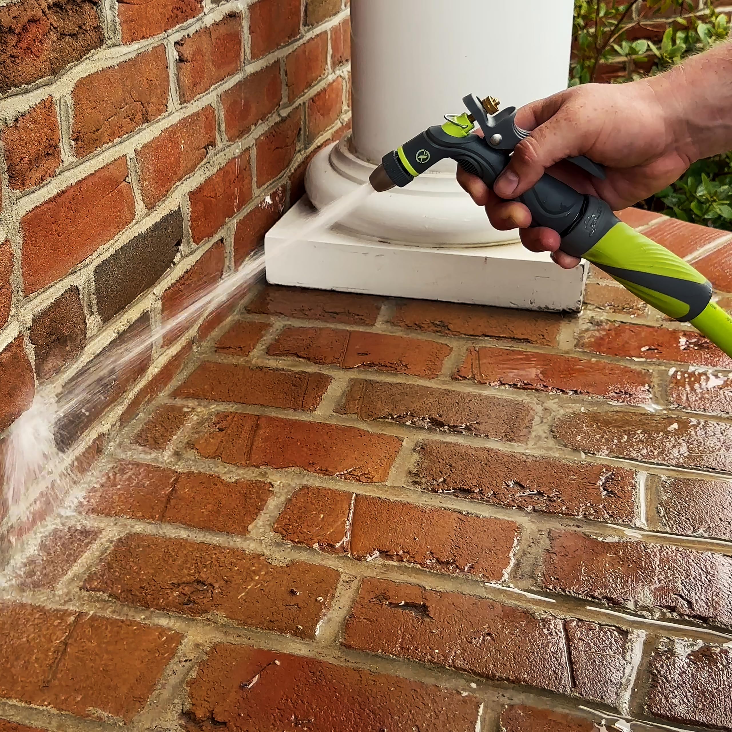 Flexzilla Metal Adjustable Pistol Grip Garden Hose Nozzle in use outdoors