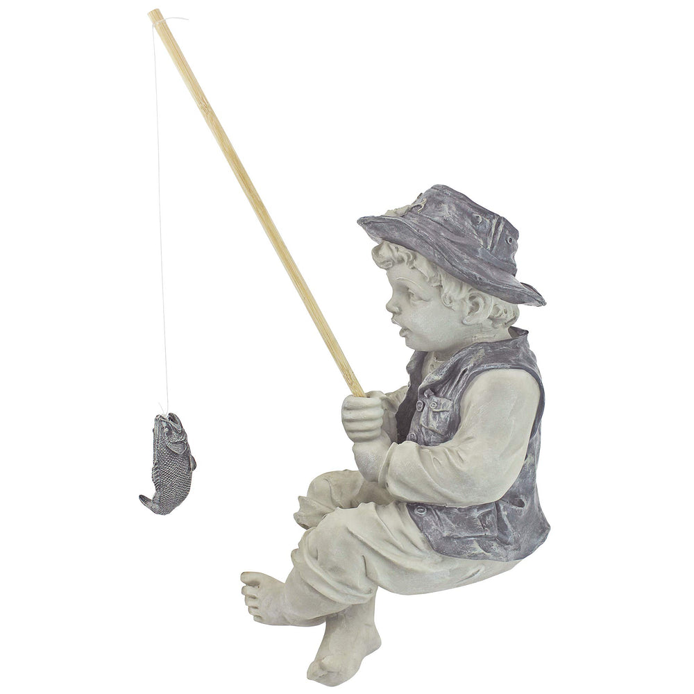 Frederic the Little Fisherman statue displayed in a Zen garden