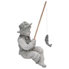 Frederic the Little Fisherman statue in garden setting next to pond